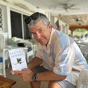 Eric Protzman holding his book